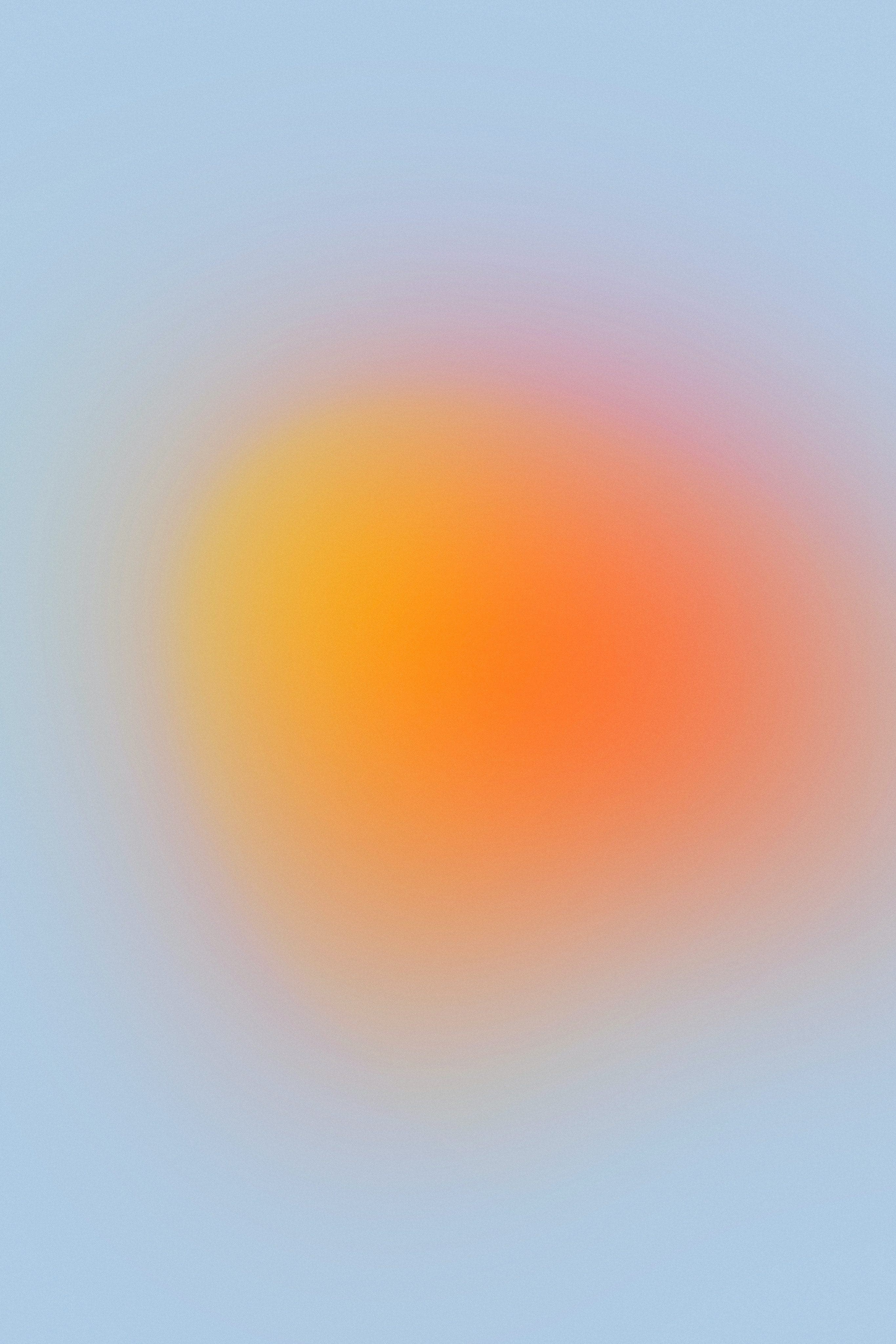 circular yellow-orange blurred radial gradient with pale blue background