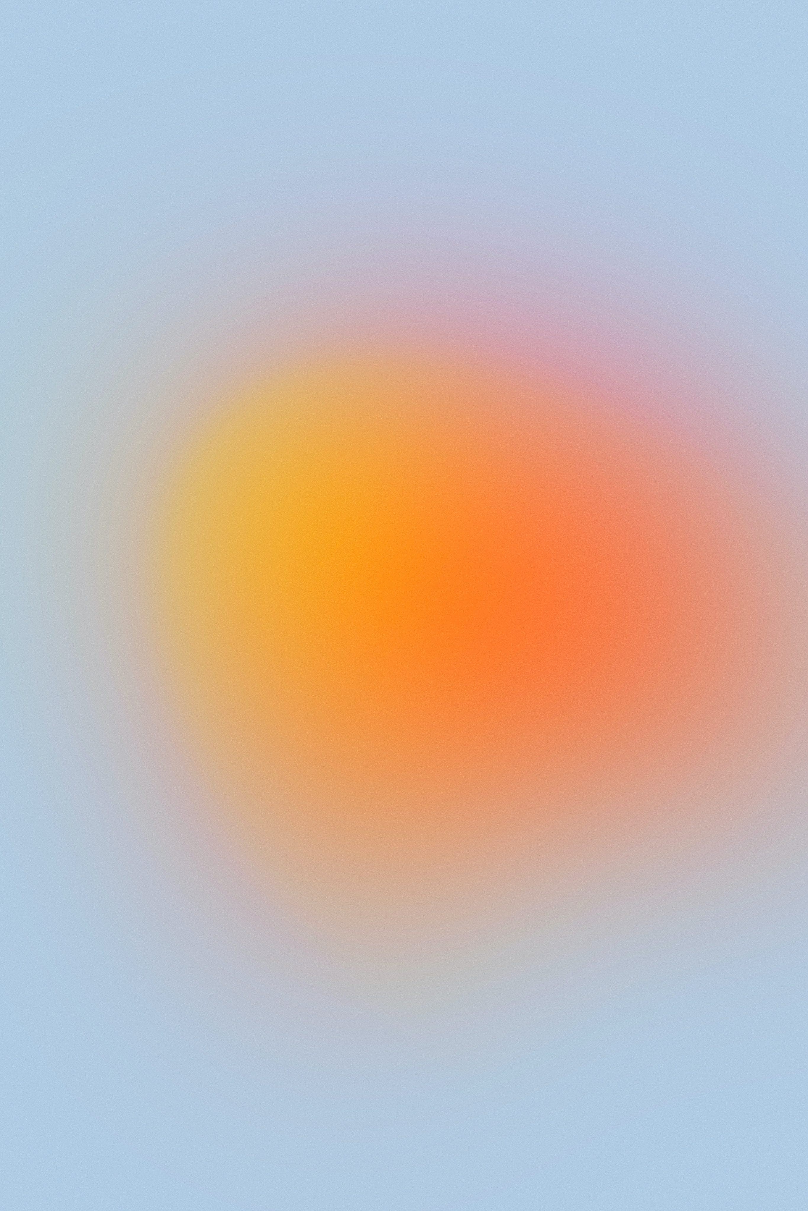 circular yellow-orange blurred radial gradient with pale blue background