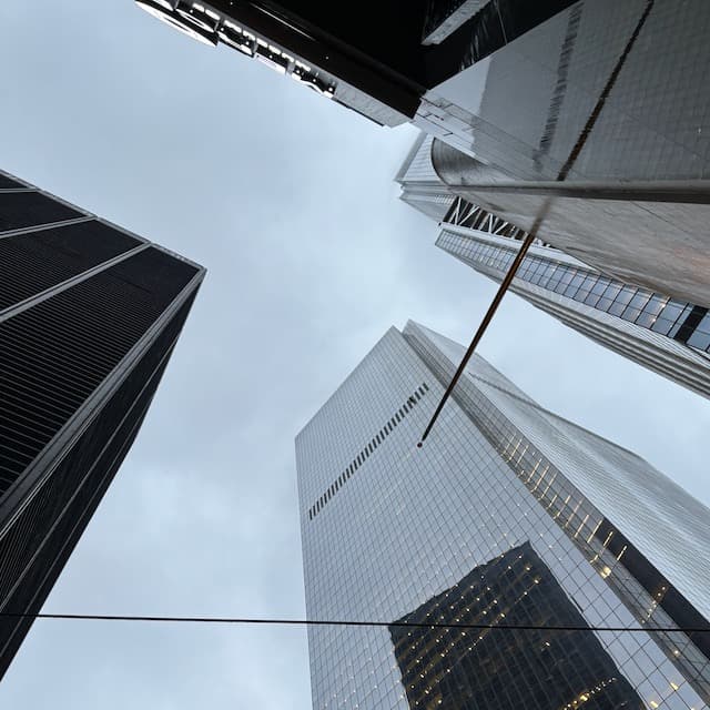 Skyscrapers viewed from below against cloudy sky